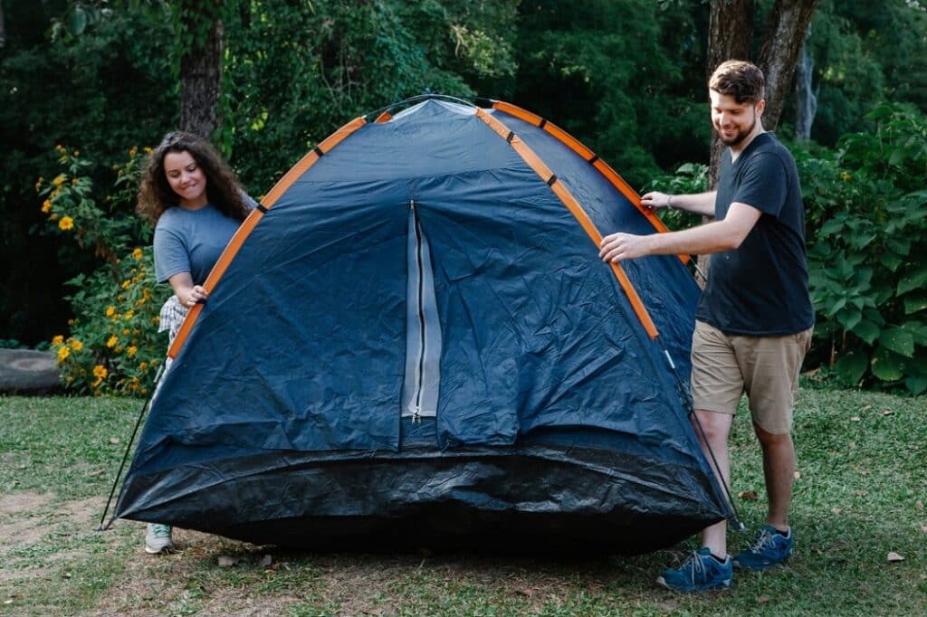 Couple pitching tent