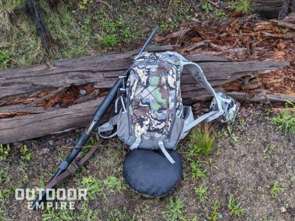Pnuma chisos backpack with rifle resting on log